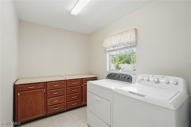 426 Chestnut Ave NW, Port Charlotte, FL 33952 - washroom with washing machine and dryer, light tile patterned floors, and cabinet space