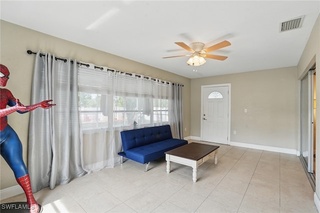 426 Chestnut Ave NW, Port Charlotte, FL 33952 - living room with ceiling fan, baseboards, and light tile patterned flooring