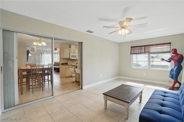 426 Chestnut Ave NW, Port Charlotte, FL 33952 - living area featuring a ceiling fan, light tile patterned floors, and baseboards