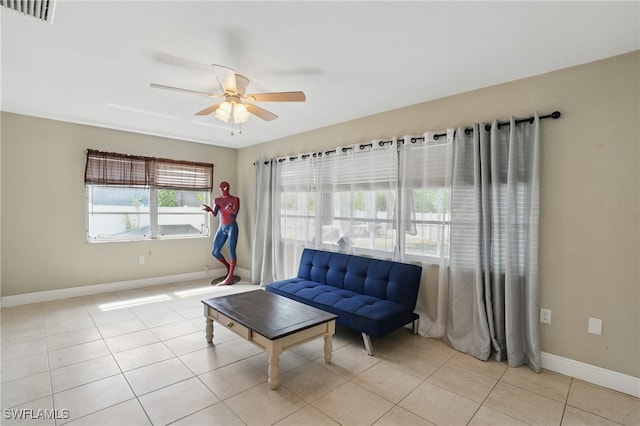 426 Chestnut Ave NW, Port Charlotte, FL 33952 - living room featuring ceiling fan, baseboards, and light tile patterned flooring