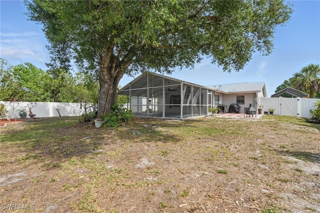 426 Chestnut Ave NW, Port Charlotte, FL 33952 - rear view of house with a patio area, a gate, and a sunroom