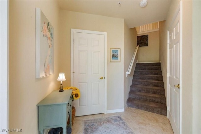 21726 Baccarat Ln Unit 201, Estero, FL 33928 - stairs with tile patterned flooring and baseboards