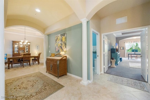21726 Baccarat Ln Unit 201, Estero, FL 33928 - hall featuring arched walkways, decorative columns, a chandelier, lofted ceiling, and baseboards