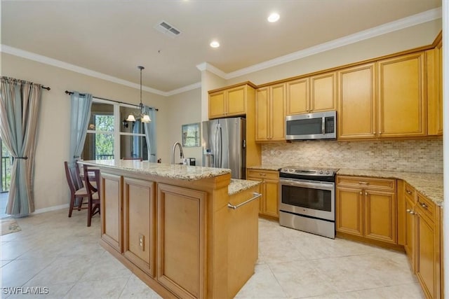 21726 Baccarat Ln Unit 201, Estero, FL 33928 - kitchen with appliances with stainless steel finishes, light stone countertops, decorative backsplash, an island with sink, and light tile patterned floors