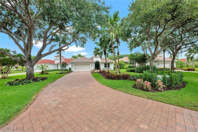 917 Tierra Lago Way, Naples, FL 34119 - mediterranean / spanish house with an attached garage, decorative driveway, and a front yard