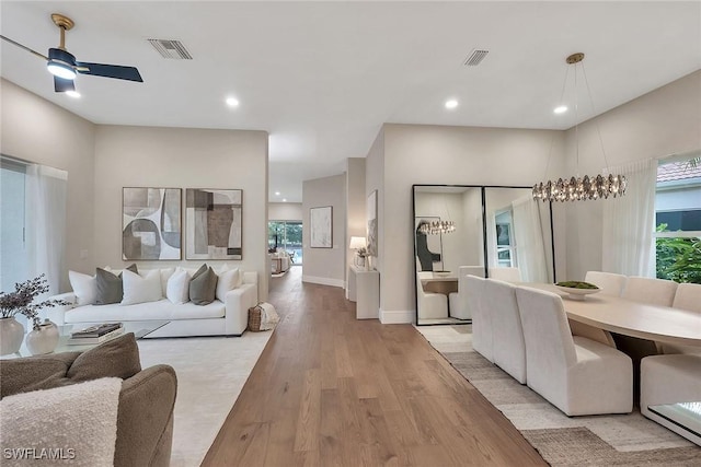 917 Tierra Lago Way, Naples, FL 34119 - living room featuring light wood-style flooring, plenty of natural light, ceiling fan, recessed lighting, and baseboards