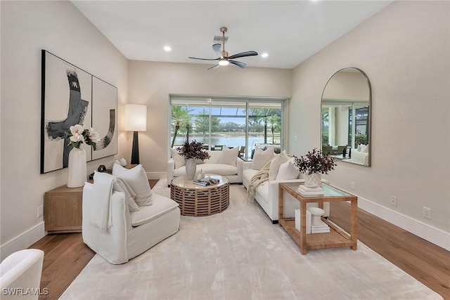 917 Tierra Lago Way, Naples, FL 34119 - living room featuring a ceiling fan, a water view, wood finished floors, recessed lighting, and baseboards