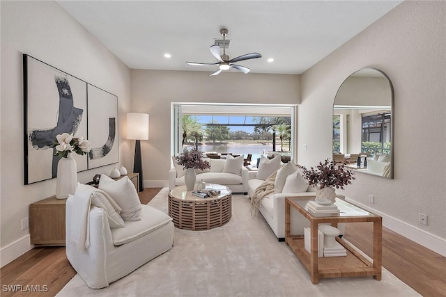917 Tierra Lago Way, Naples, FL 34119 - living room featuring wood finished floors, a water view, a ceiling fan, baseboards, and recessed lighting