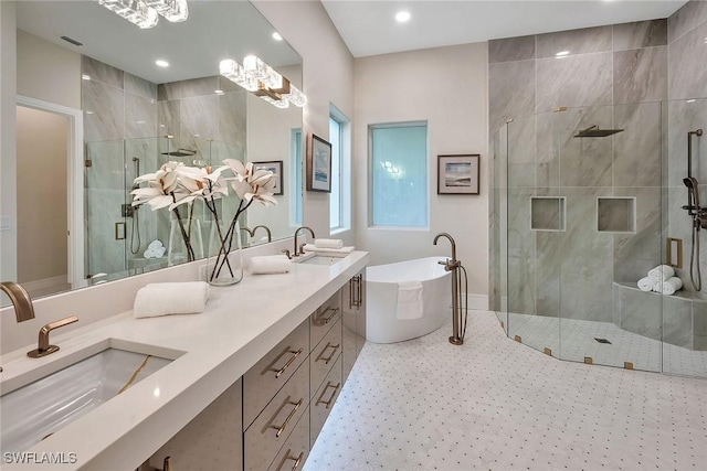 917 Tierra Lago Way, Naples, FL 34119 - full bathroom with a shower stall, double vanity, a freestanding tub, and recessed lighting