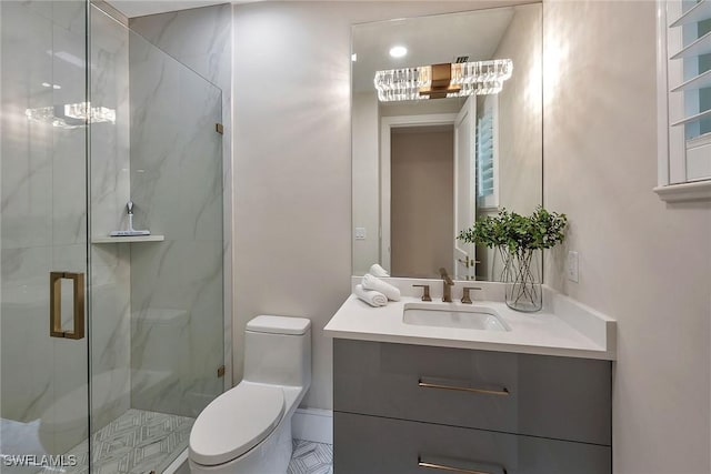 917 Tierra Lago Way, Naples, FL 34119 - bathroom featuring a chandelier, toilet, vanity, and a marble finish shower