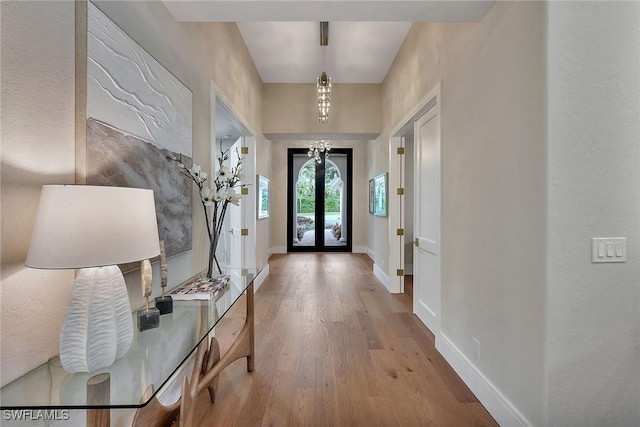 917 Tierra Lago Way, Naples, FL 34119 - entryway with wood finished floors, baseboards, and french doors