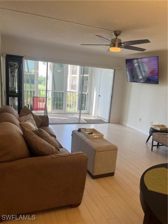 1740 Pine Valley Dr Unit 205, Fort Myers, FL 33907 - living room with ceiling fan, light wood-type flooring, and baseboards