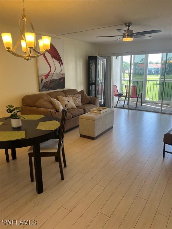 1740 Pine Valley Dr Unit 205, Fort Myers, FL 33907 - living room featuring a chandelier, light wood-type flooring, and ceiling fan