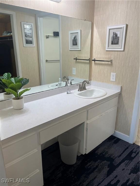 1740 Pine Valley Dr Unit 205, Fort Myers, FL 33907 - bathroom with vanity and wallpapered walls