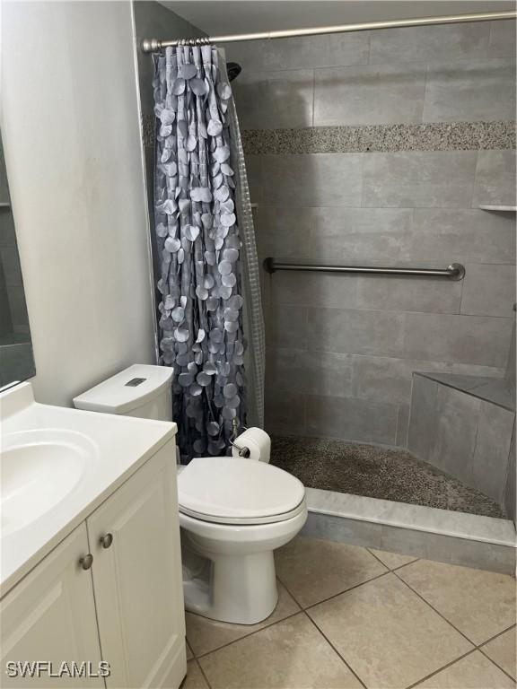 1740 Pine Valley Dr Unit 205, Fort Myers, FL 33907 - full bathroom with vanity, toilet, a tile shower, and tile patterned floors