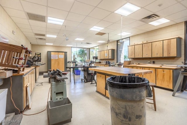 1740 Pine Valley Dr Unit 205, Fort Myers, FL 33907 - kitchen with wooden counters, a center island, and a drop ceiling