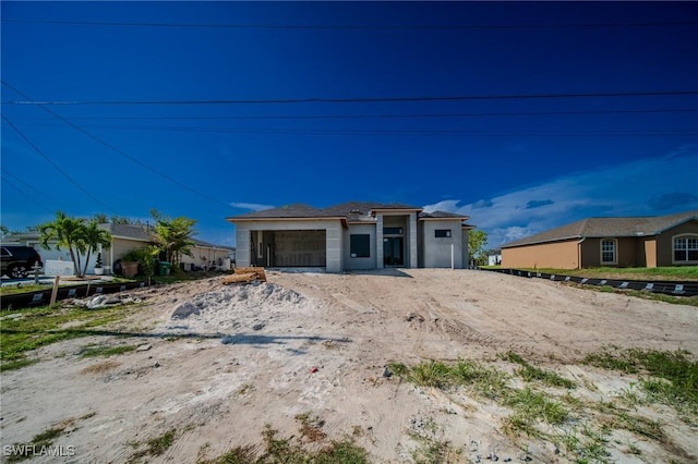 315 NW 10th St, Cape Coral, FL 33993 - view of front of house featuring a garage and driveway