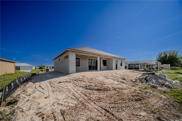 315 NW 10th St, Cape Coral, FL 33993 - rear view of property featuring stucco siding