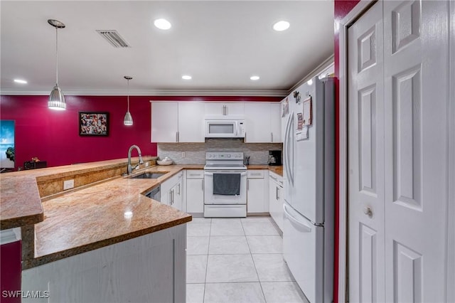 4520 Douglas Ln, Lehigh Acres, FL 33973 - kitchen featuring white appliances, a sink, a peninsula, white cabinets, and crown molding