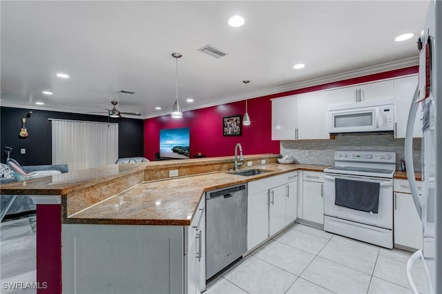 4520 Douglas Ln, Lehigh Acres, FL 33973 - kitchen with white appliances, a sink, a peninsula, white cabinets, and hanging light fixtures