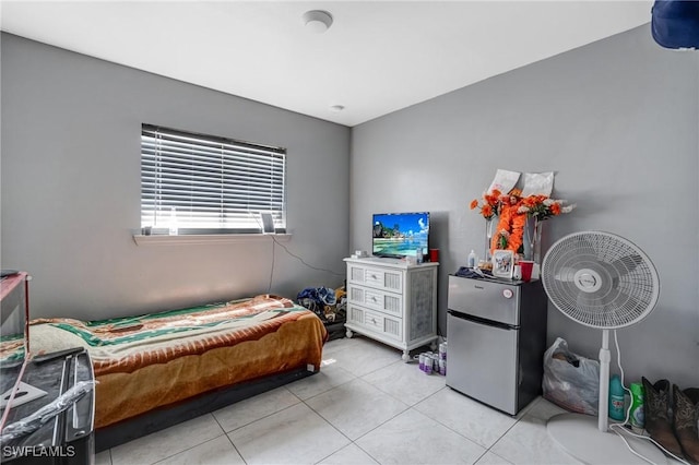 4520 Douglas Ln, Lehigh Acres, FL 33973 - bedroom with freestanding refrigerator and light tile patterned floors