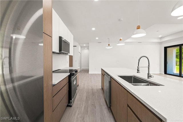 3203 18th St W, Lehigh Acres, FL 33971 - kitchen with appliances with stainless steel finishes, a sink, modern cabinets, white cabinetry, and recessed lighting