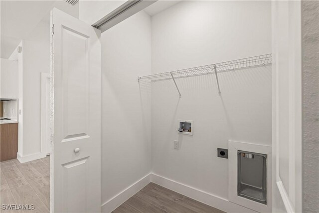 3203 18th St W, Lehigh Acres, FL 33971 - washroom with electric dryer hookup, light wood-style floors, washer hookup, and baseboards