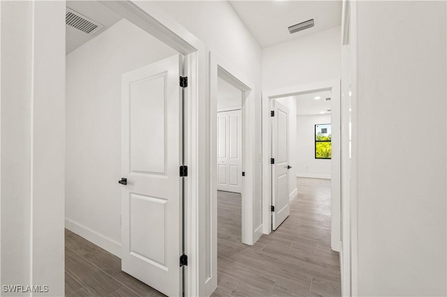 3203 18th St W, Lehigh Acres, FL 33971 - hallway with baseboards and wood finished floors