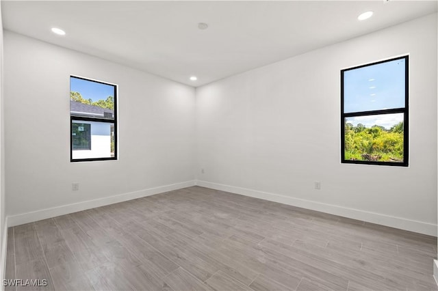 3203 18th St W, Lehigh Acres, FL 33971 - empty room with light wood-style floors, baseboards, and recessed lighting