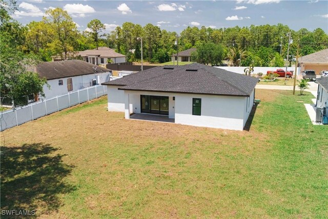 3203 18th St W, Lehigh Acres, FL 33971 - back of property featuring a shingled roof and stucco siding