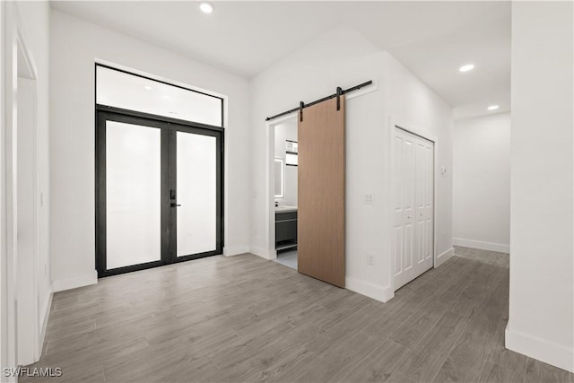 3203 18th St W, Lehigh Acres, FL 33971 - entrance foyer with a barn door, wood finished floors, baseboards, and recessed lighting