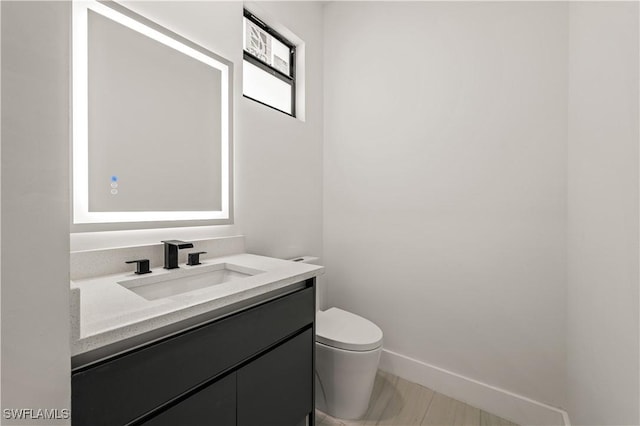 3203 18th St W, Lehigh Acres, FL 33971 - bathroom with toilet, vanity, and baseboards