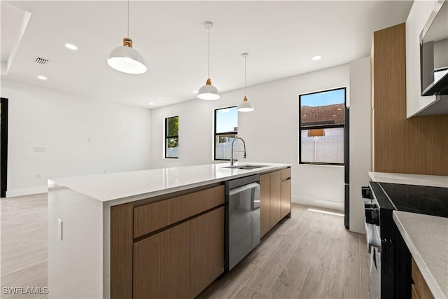 3203 18th St W, Lehigh Acres, FL 33971 - kitchen with a sink, stainless steel appliances, plenty of natural light, light wood-style floors, and recessed lighting