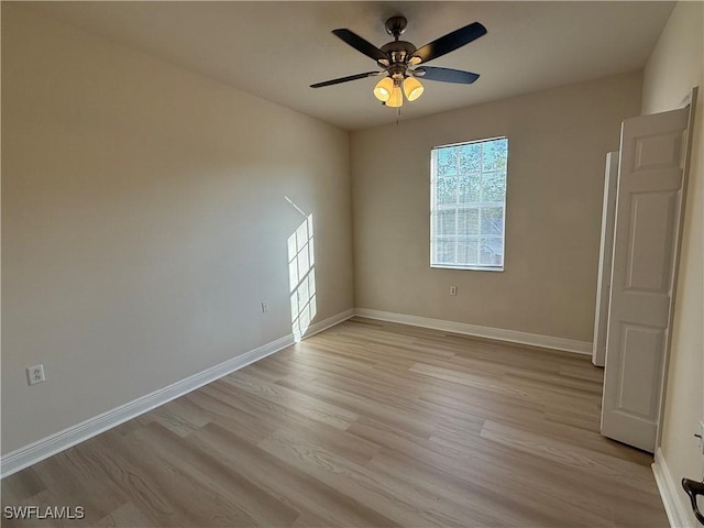 3947 Del Sol Ln Unit 203, Cape Coral, FL 33909 - empty room featuring light wood-style floors, a ceiling fan, and baseboards