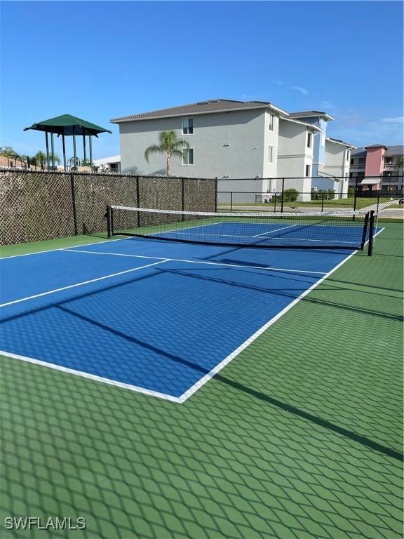 3947 Del Sol Ln Unit 203, Cape Coral, FL 33909 - view of tennis court with community basketball court