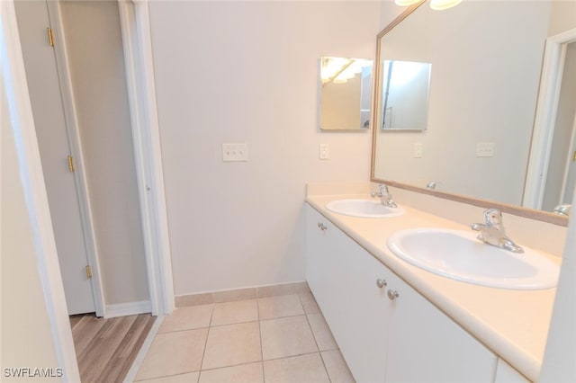8331 Bernwood Cove Loop W Unit 1402, Fort Myers, FL 33966 - bathroom with double vanity, baseboards, and tile patterned flooring