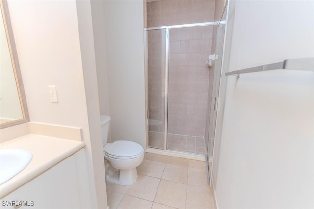 8331 Bernwood Cove Loop W Unit 1402, Fort Myers, FL 33966 - bathroom featuring toilet, a stall shower, vanity, and tile patterned floors