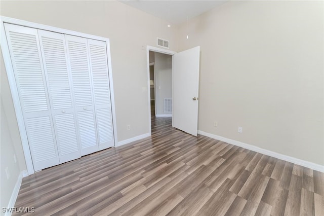 8331 Bernwood Cove Loop W Unit 1402, Fort Myers, FL 33966 - unfurnished bedroom with wood finished floors, a closet, and baseboards