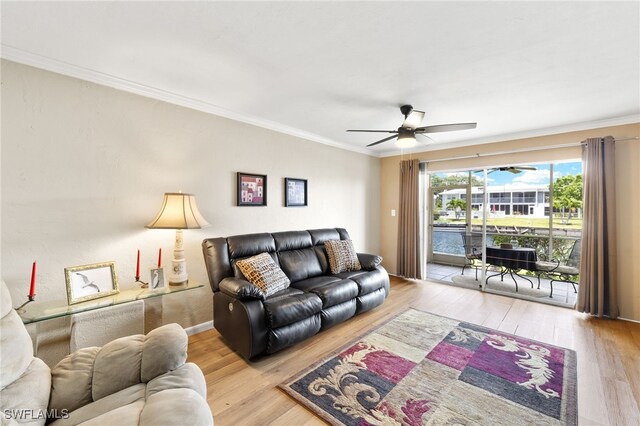 909 SE 46th Ln Unit 104, Cape Coral, FL 33904 - living area with wood finished floors, a ceiling fan, and ornamental molding