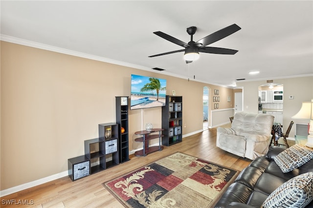 909 SE 46th Ln Unit 104, Cape Coral, FL 33904 - living area with ceiling fan, arched walkways, crown molding, wood finished floors, and baseboards