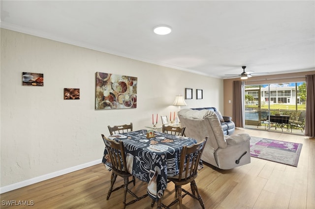 909 SE 46th Ln Unit 104, Cape Coral, FL 33904 - dining area featuring wood finished floors, crown molding, a ceiling fan, and baseboards