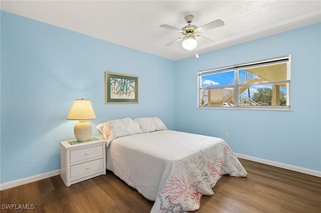 909 SE 46th Ln Unit 104, Cape Coral, FL 33904 - bedroom featuring baseboards, wood finished floors, and a ceiling fan