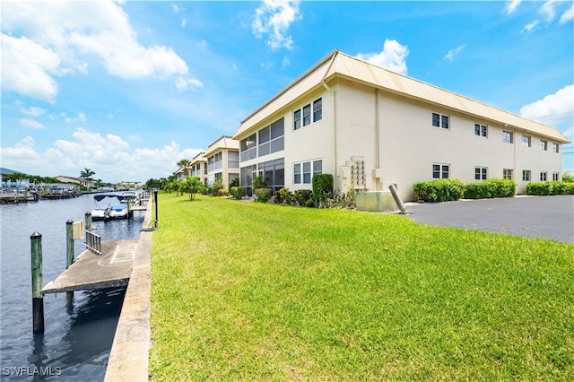 909 SE 46th Ln Unit 104, Cape Coral, FL 33904 - dock with a yard and a water view