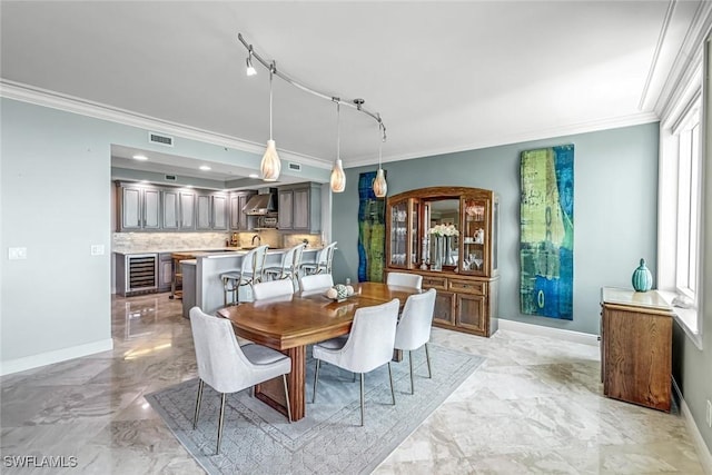 275 Indies Way Unit 1603, Naples, FL 34110 - dining space with ornamental molding, wine cooler, baseboards, and light marble finish flooring