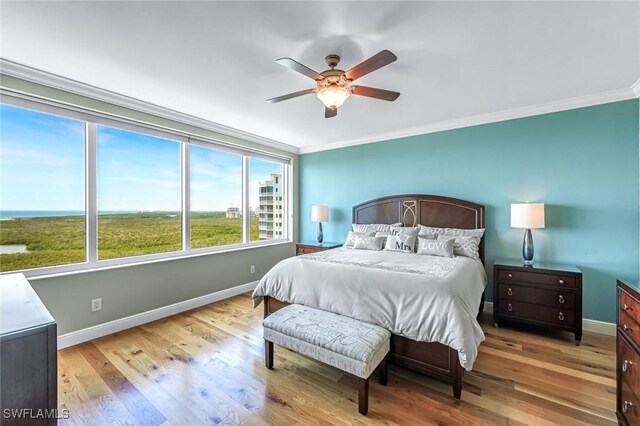 275 Indies Way Unit 1603, Naples, FL 34110 - bedroom with ornamental molding, baseboards, wood finished floors, and a ceiling fan