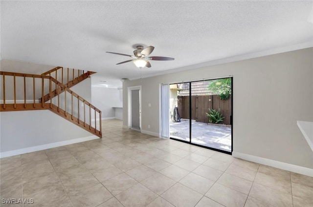 1501 Park Meadows Dr Unit 3, Fort Myers, FL 33907 - unfurnished room with a ceiling fan, a textured ceiling, stairway, and baseboards