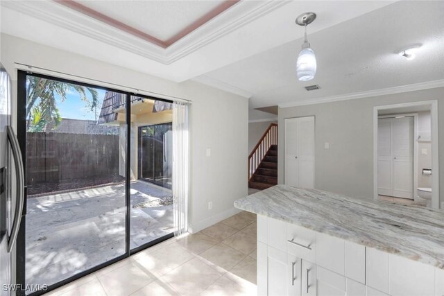 1501 Park Meadows Dr Unit 3, Fort Myers, FL 33907 - kitchen featuring crown molding, white cabinets, hanging light fixtures, light stone countertops, and light tile patterned flooring