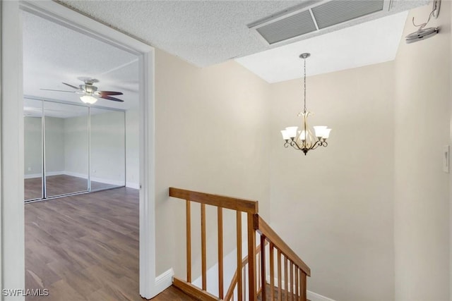 1501 Park Meadows Dr Unit 3, Fort Myers, FL 33907 - hallway with an upstairs landing, wood finished floors, baseboards, a chandelier, and a textured ceiling