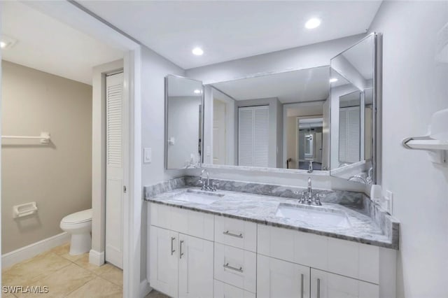 1501 Park Meadows Dr Unit 3, Fort Myers, FL 33907 - bathroom featuring a closet, double vanity, toilet, baseboards, and recessed lighting