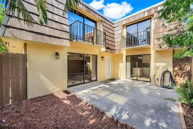 1501 Park Meadows Dr Unit 3, Fort Myers, FL 33907 - rear view of house with a balcony, stucco siding, a patio, and mansard roof